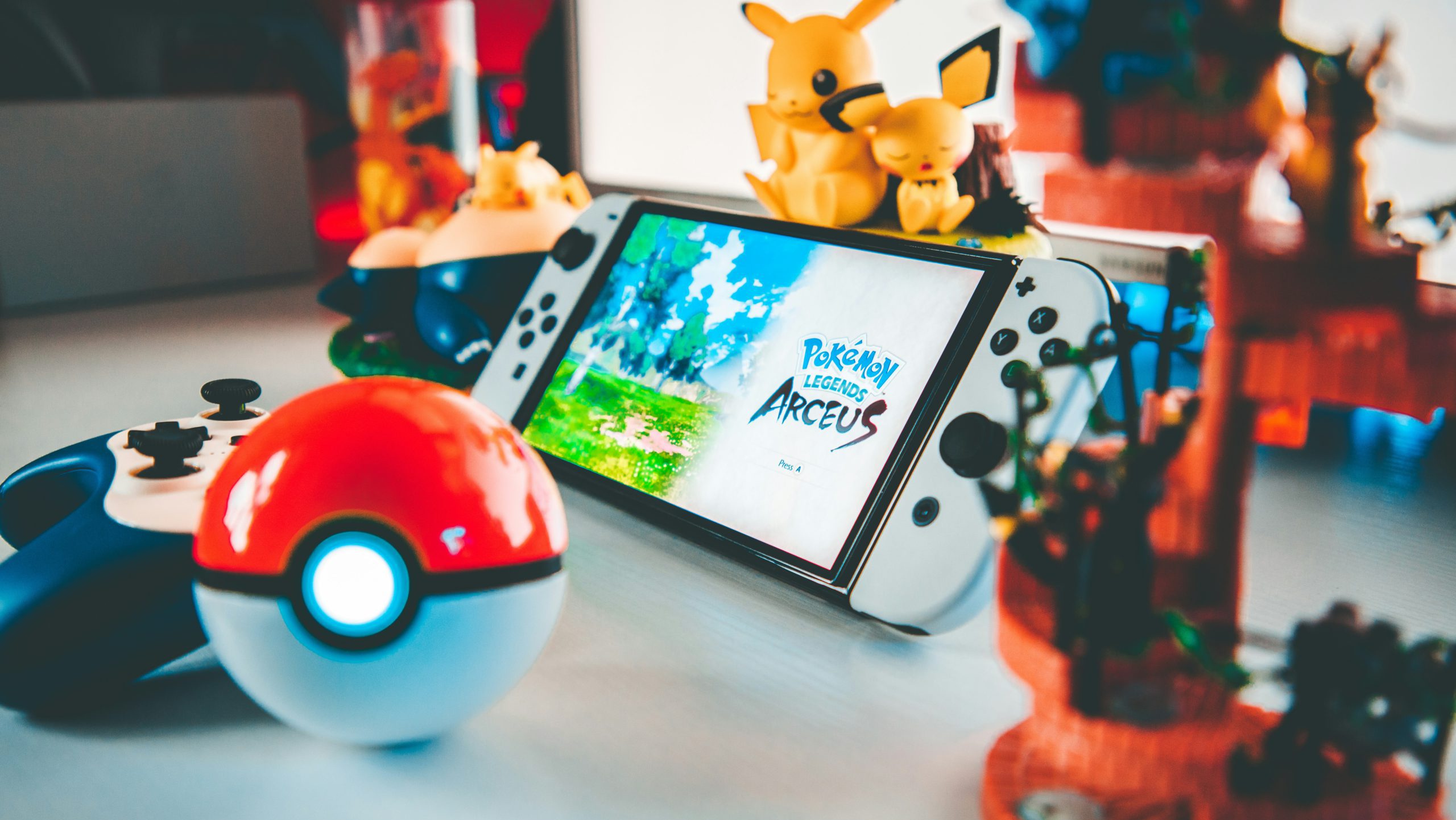 collection of pokemon products on a table including pikachu, pokeball, nintendo switch