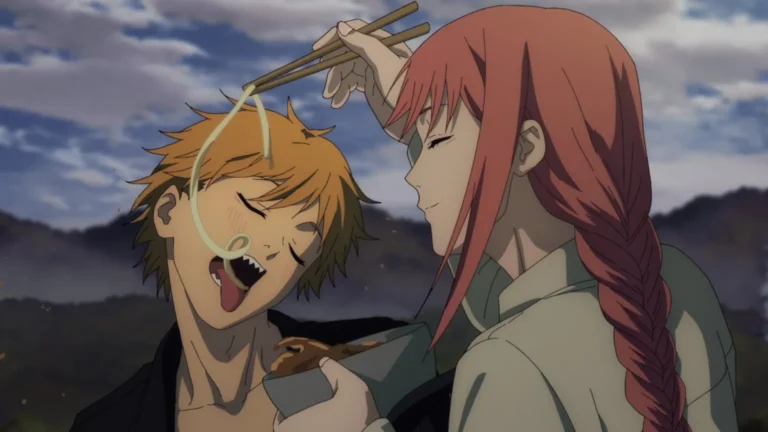 woman feeding noodle to boy